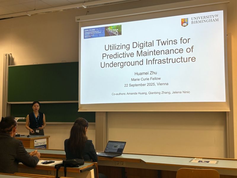 Huamei Zhu presenting at EURO:TUN 2025 in Vienna, with the talk title slide on screen.