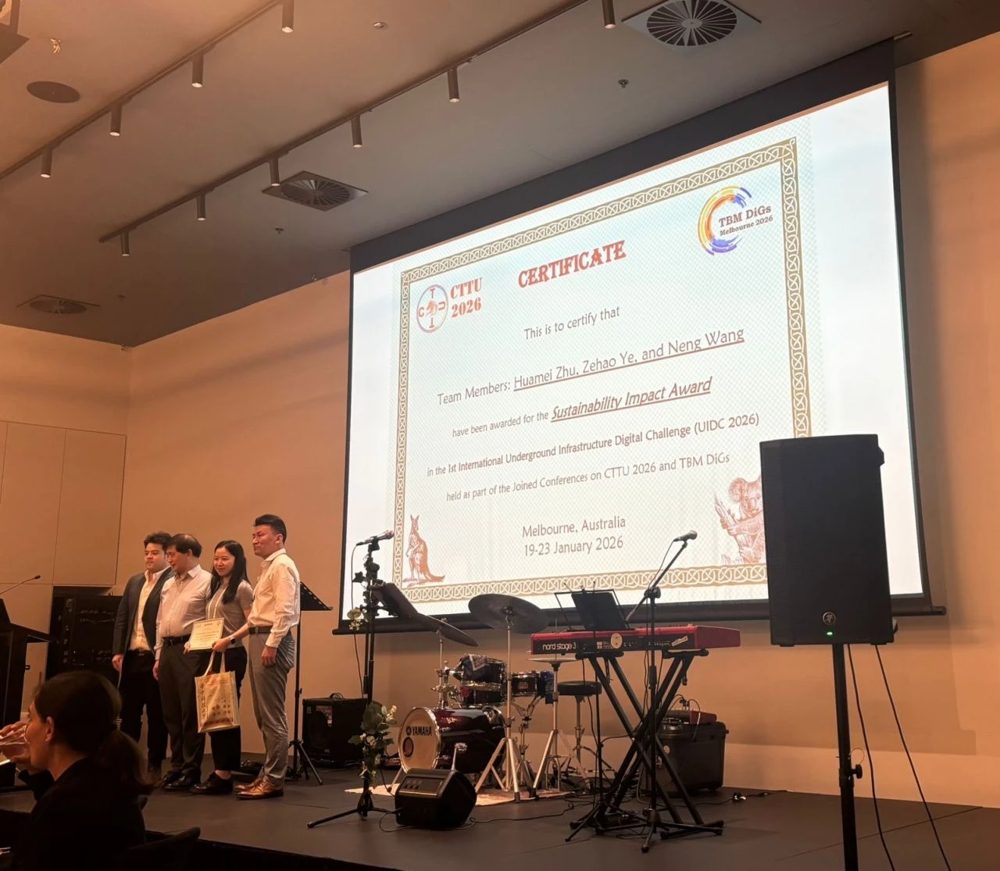 Huamei Zhu and team receiving the Sustainability Impact Award at UIDC 2026 in Melbourne.